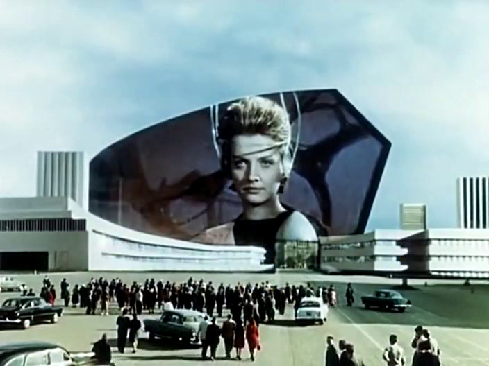 An alien woman on a big public screen.