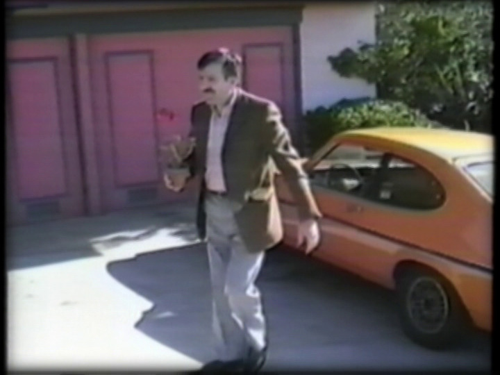 A suitor shows up in an orange sports car.