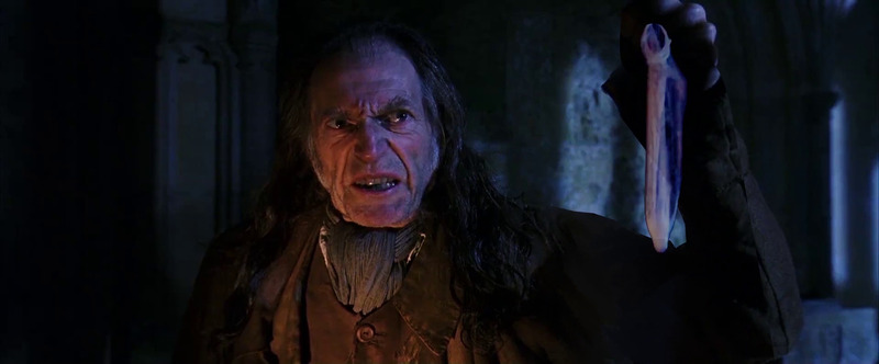Filch holds up a used condom.