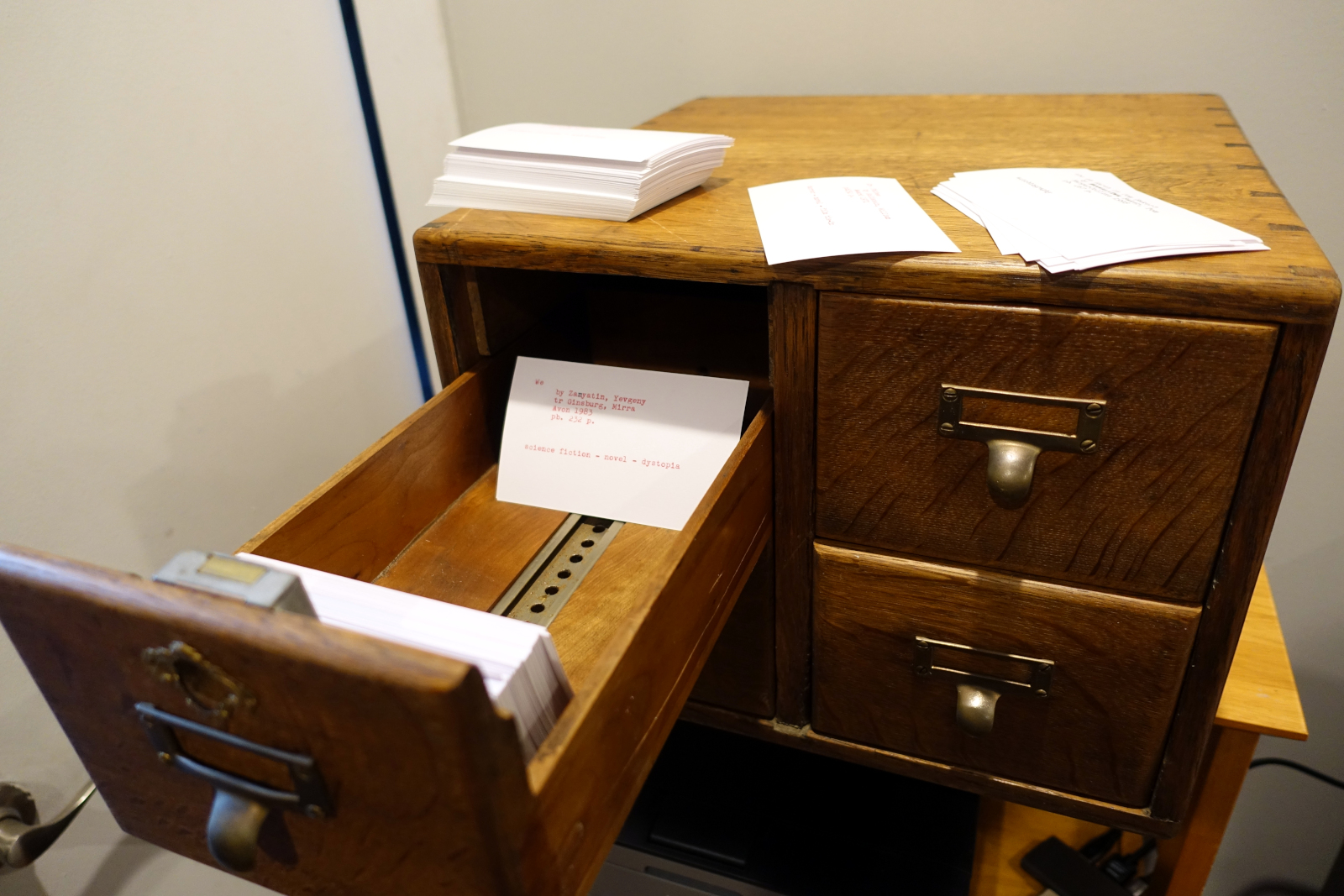 A wood card catalogue with four drawers.