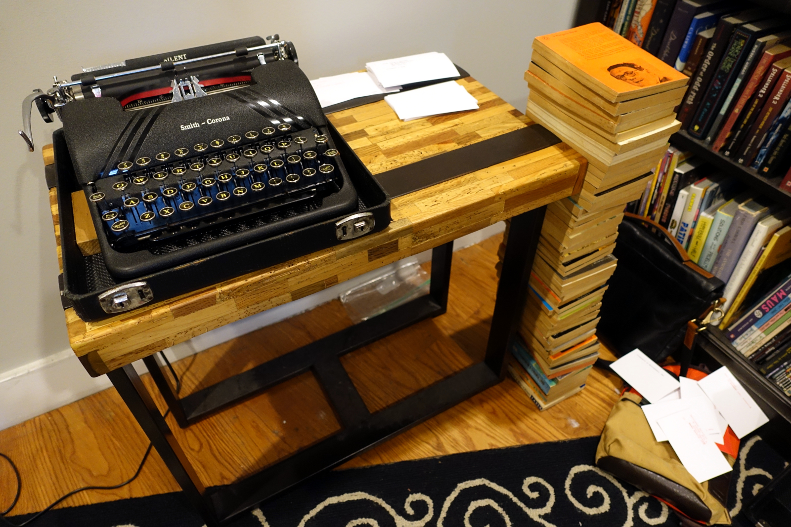 A manual typewriter on a table with white index cards.